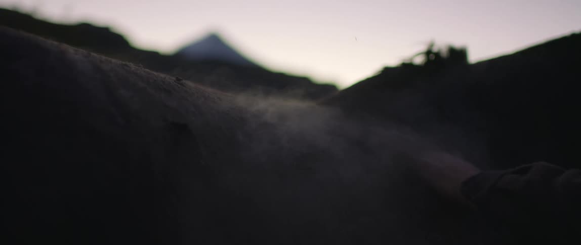 A man wiping dirt away outside