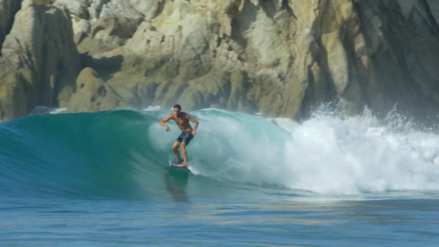 A man surfing on a large wave
