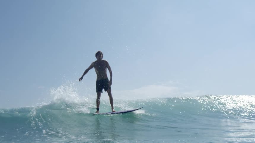 A man is surfing a small wave