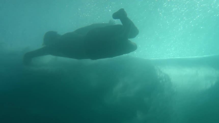 Man swims in moving water