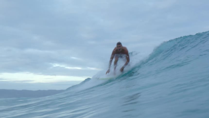 A man surfing on a large wave