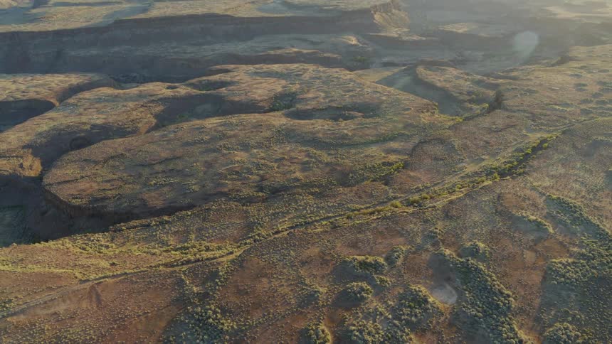 Slow pullback reveal of a vast and insane landscape of sculpted rock plateaus