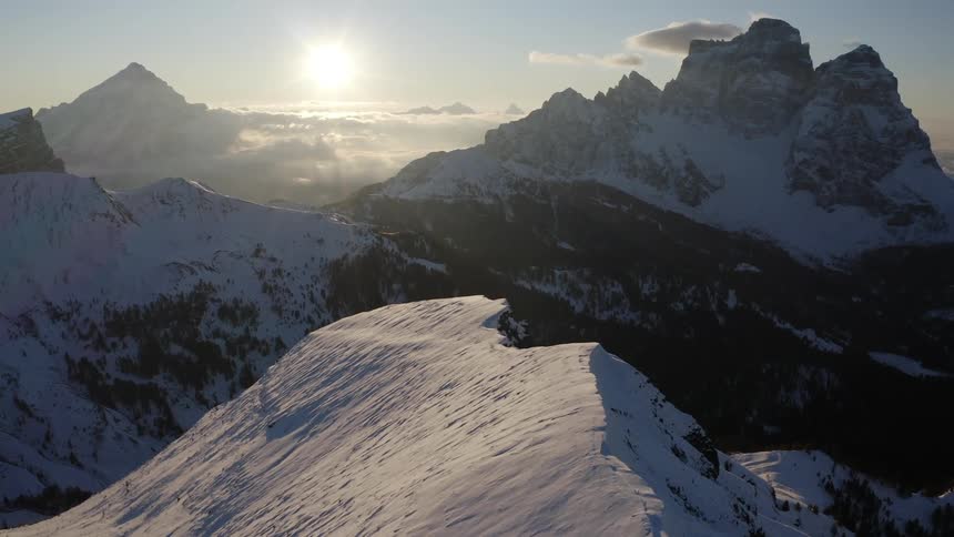 The sun shines on a mountain range