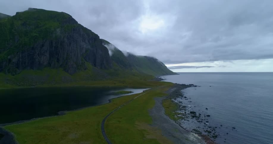 Coastline with mountain and a cloudy sky