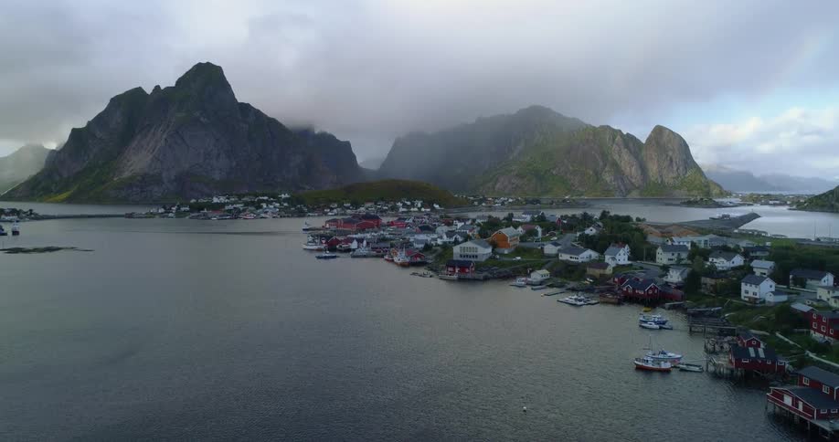 Fog sets over a marina surrounded with boats