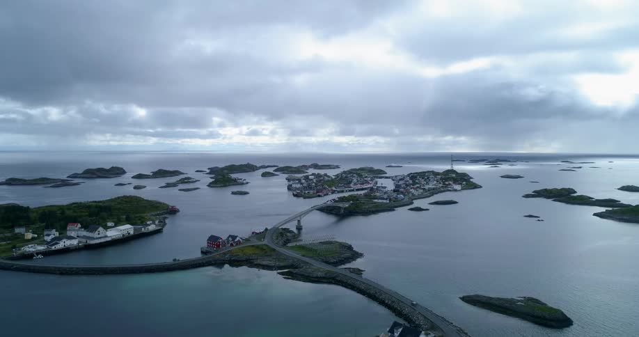 An aerial view of a car driving over a bridge connecting islands