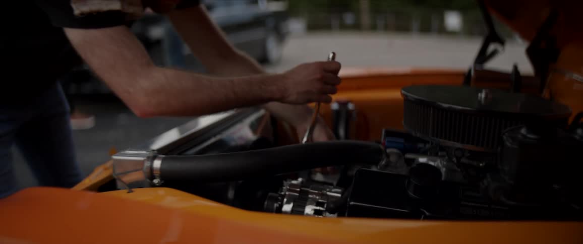 Men are working on their cars on the road