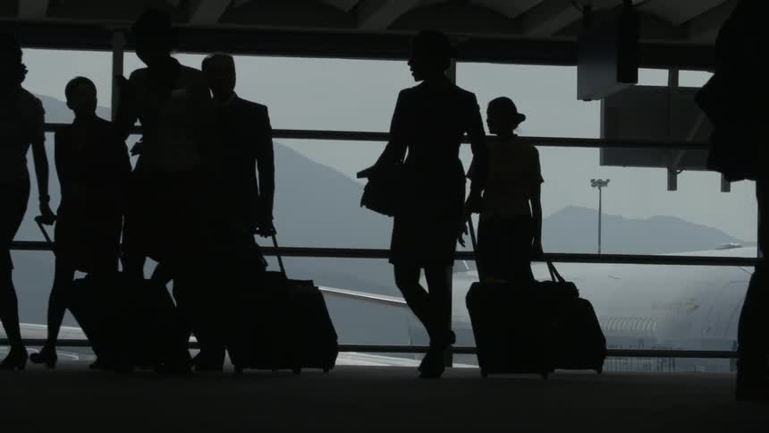 Women with luggage walking in an airport