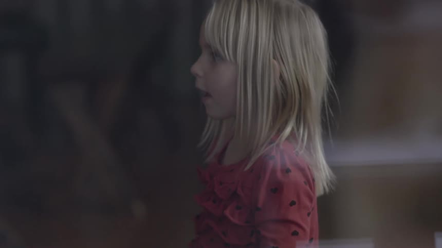 Little girl standing and staring off