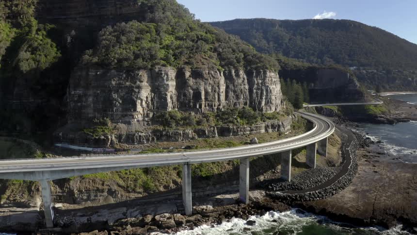 An aerial view of a highway on the coast