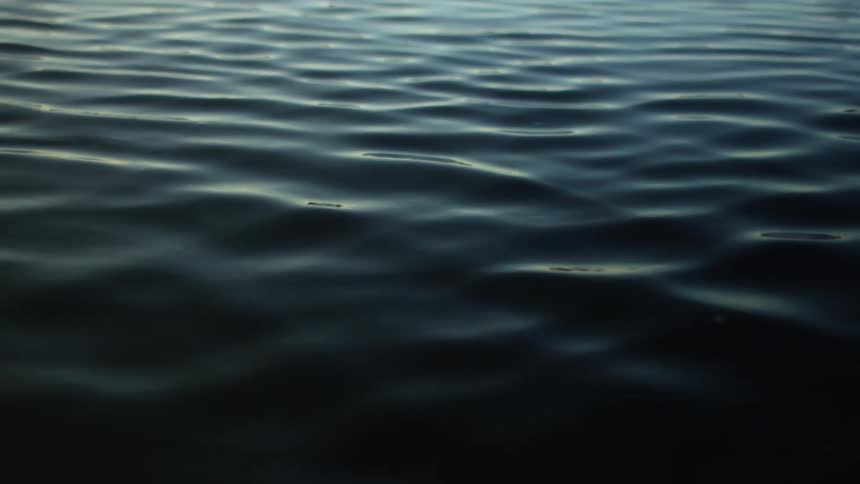 Dark water with small waves moving forward