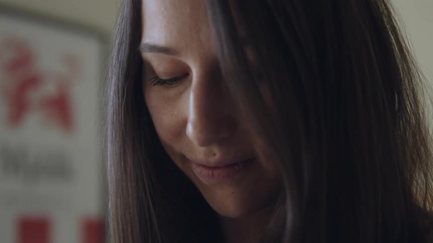 Close up of a long haired woman in a room at home