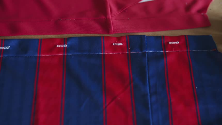 Red and blue fabric next to magenta fabric on a table