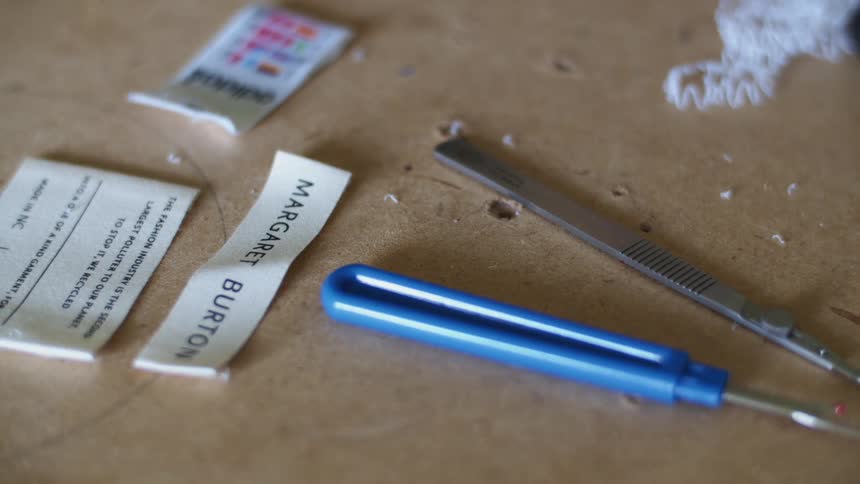Close up of sewing supplies laying over a table