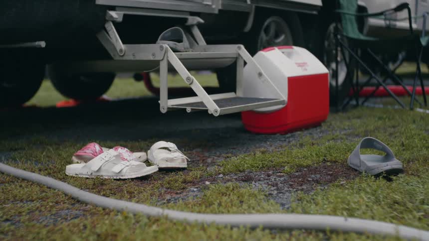 A rv is set up in the grass