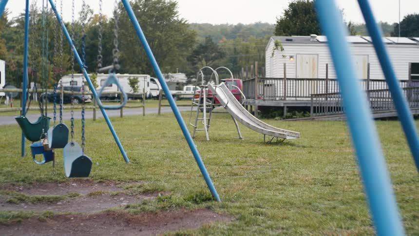 View of an empty playground with slides and swings