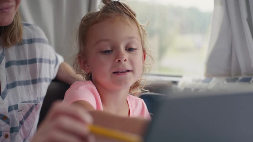 Mother helping daughter with homework at home