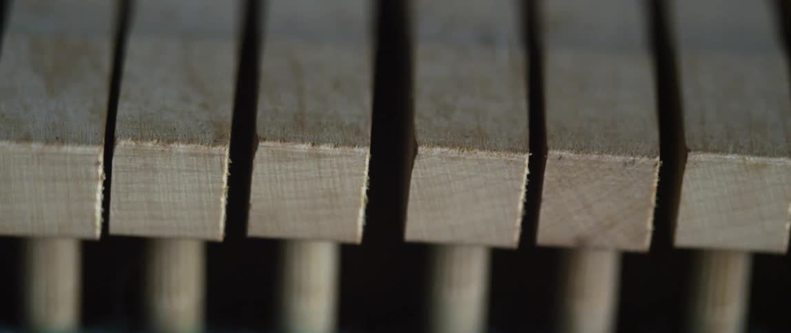 A close up of a piano hitting notes