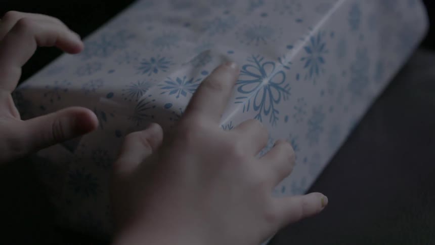 A person is wrapping a present