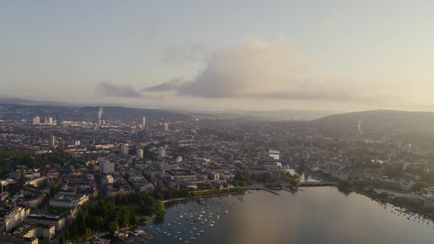 Aerial view of the pier on the coast of a city at sunset