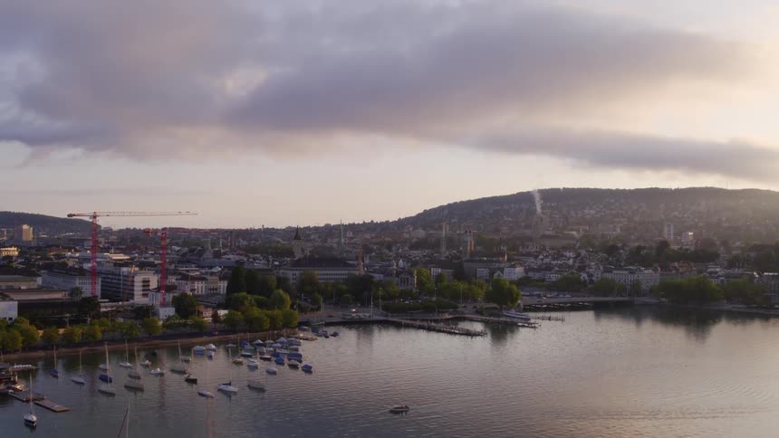The boats are docked at the pier at sunrise