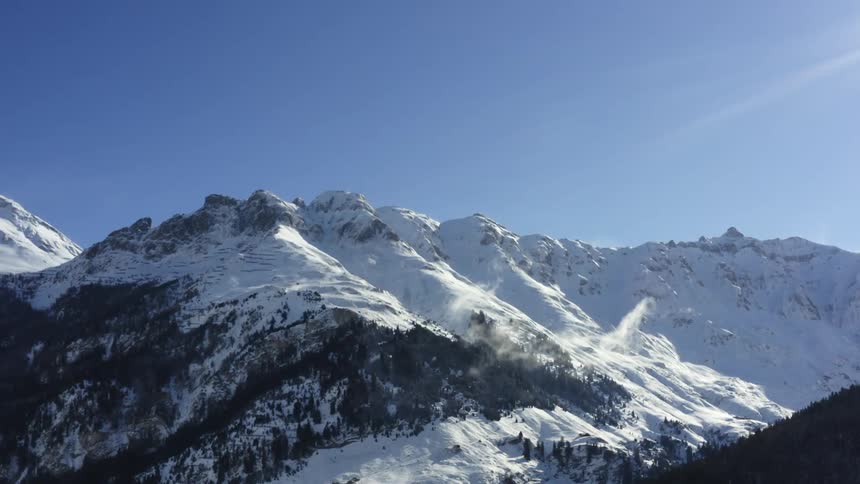 Aerial view of snow covered mountains are displayed