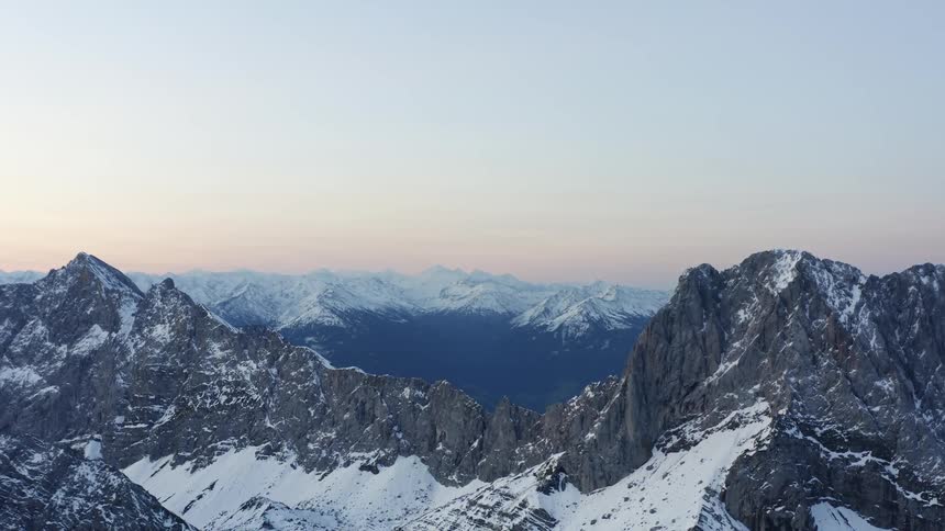 Aerial view of snow covered mountains are displayed