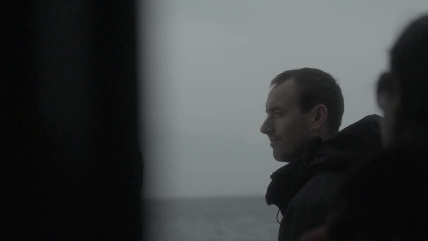 A man looks out and smiles