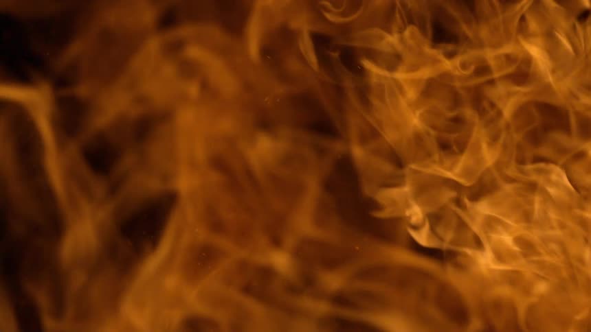Flames and smoke rising on a black background