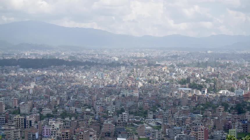 View of a large spread out city on a very cloudy day