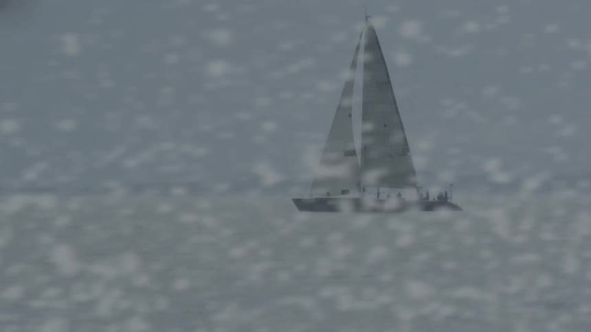 A boat is sailing in the water on a cloudy day