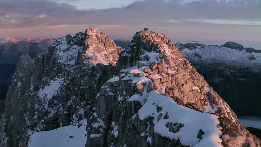 Aerial view of a mountain range with snow on the summit