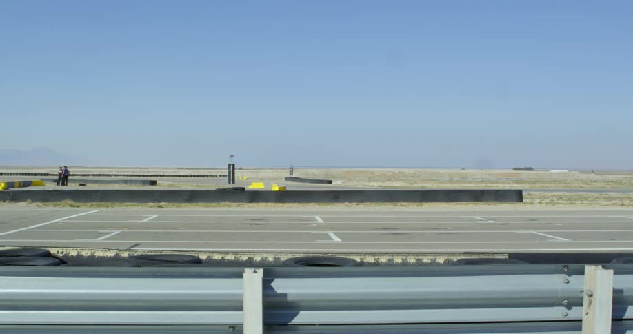 Go karts racing on a speedway in a desert area at daytime