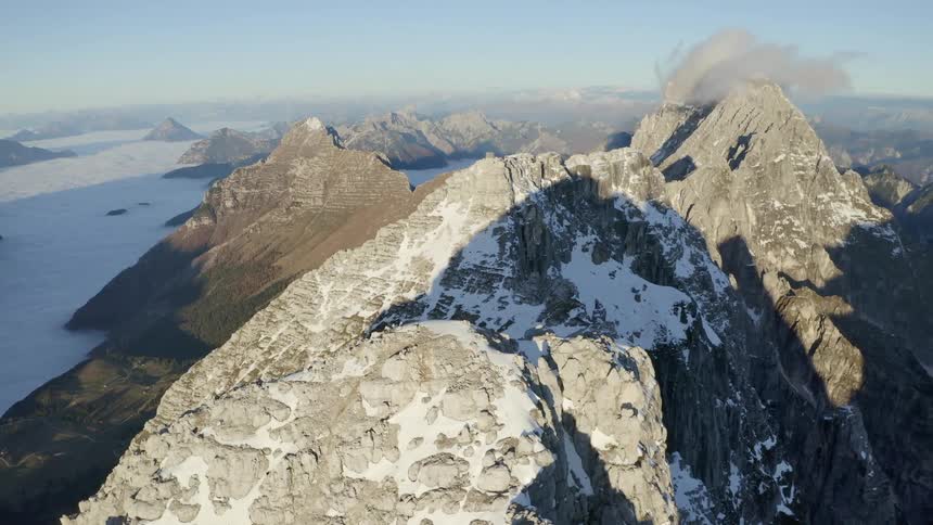 An aerial view of snowy mountain ranges in the daytime