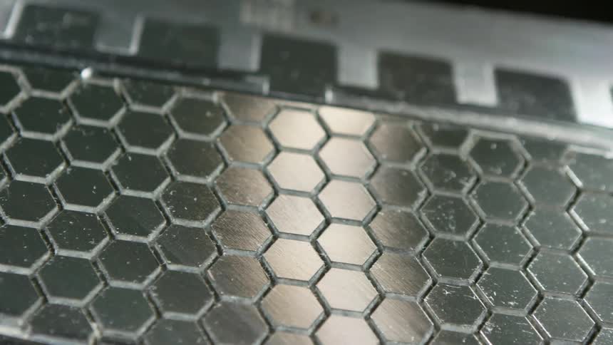Silver metal slab with hexagon shapes etched into the surface