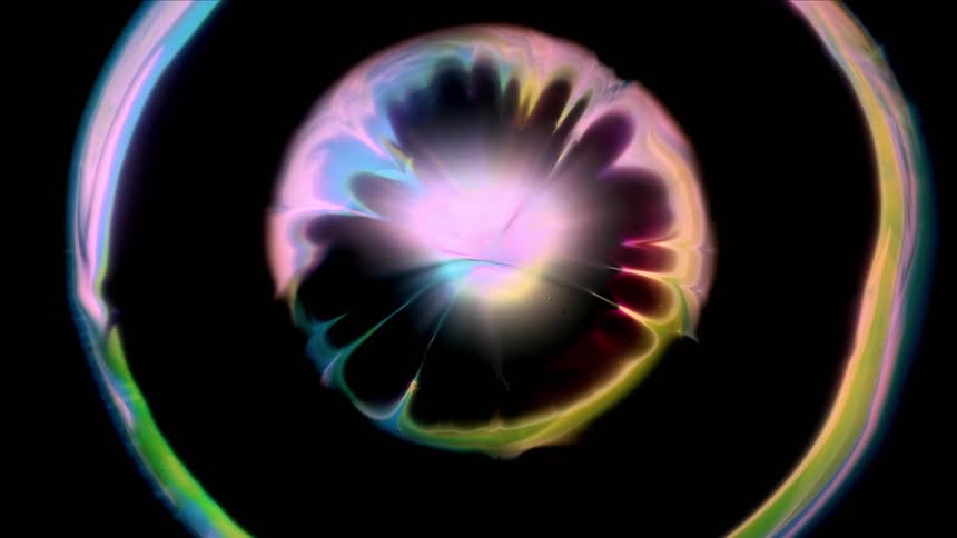 Abstract colors moving outwards in a circle in pink yellow and blue colors