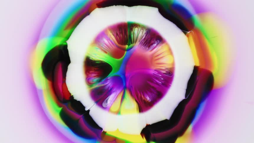 Liquid explosion of colors under a microscope expanding outwards