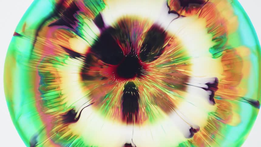 Abstract movement of colors bursting into circles that radiate out