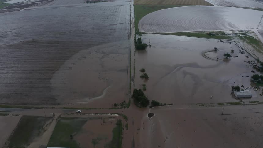 Aerial shot looking down on a farm during a major flood event showing how farm fun off moves into streams and waterways as nutrients and hauled downstream
