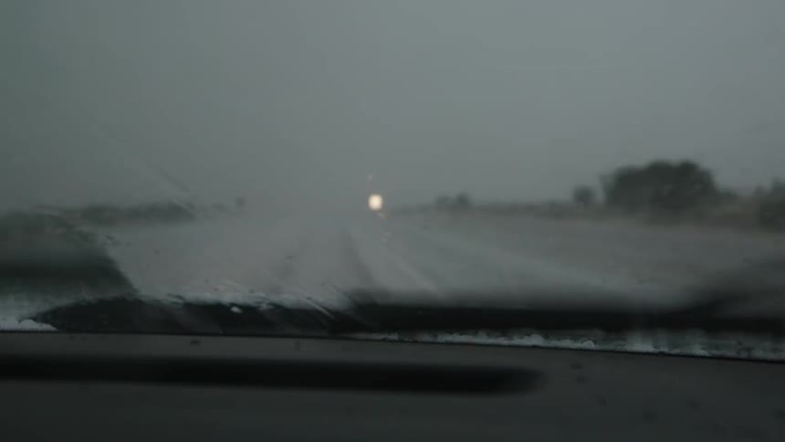 Hail pounds the windshield as the wipers struggle to clear the hail stones quickly enough in this real time shot