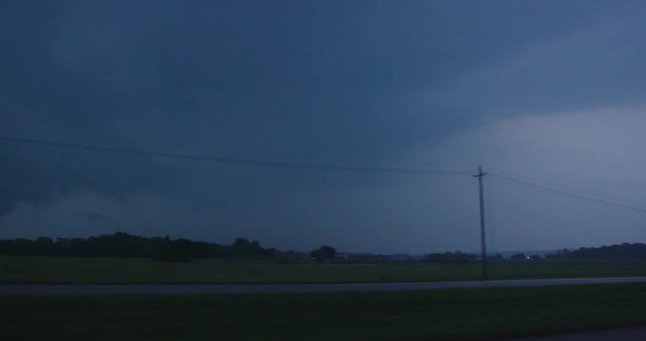 Real time shot of heavy and intense cloud to ground lightning strikes the ground outside the window of our moving car, very close
