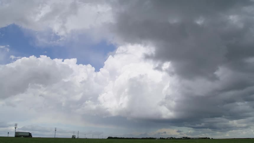 Time lapse of a massive blllowig severe thunderstorm clouds build over a rural Kansas landscape