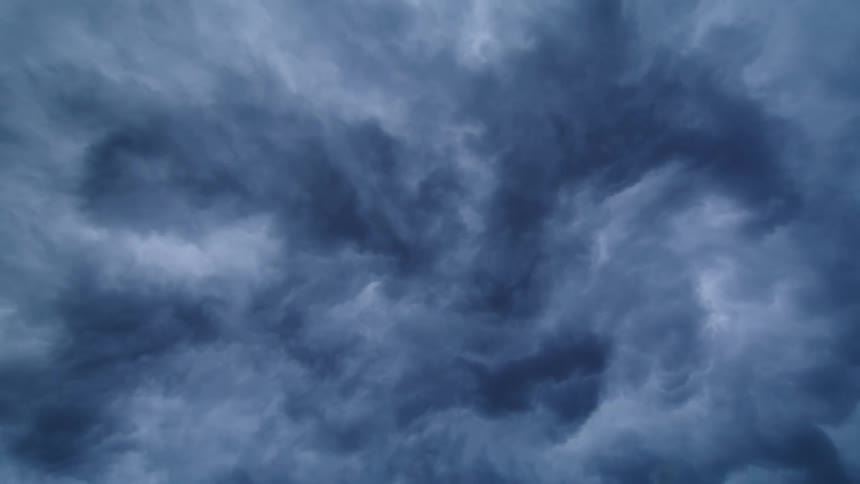 Time lapse looking straight up at storm clouds that resemble ink in water or ocean currents swirling about in the sky in a mesmerizing motion