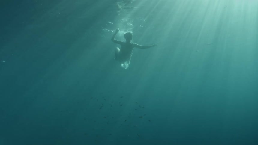 A person underwater diving and swimming