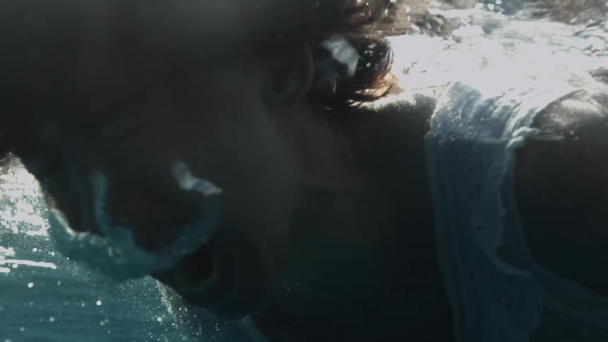 A woman screams while underwater