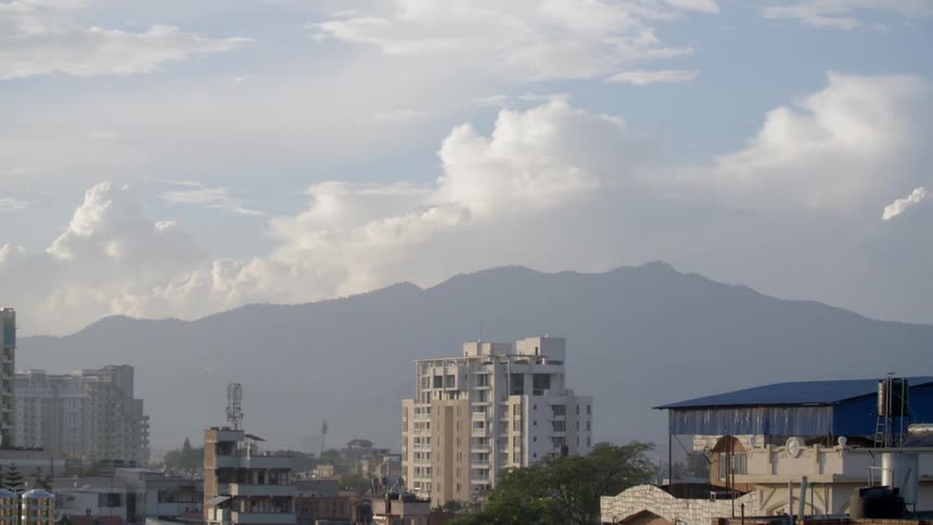 A skyline with many clouds above a city