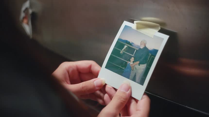 Woman holds and looks at a photograph