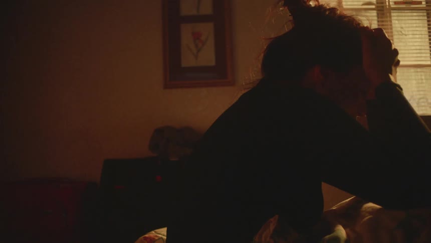 Woman wakes up from a dream in bed and starts to pant with her hands on her face
