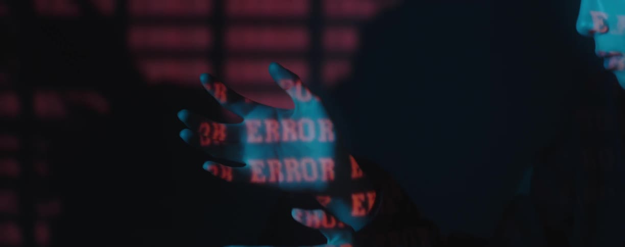 A teenage boy looks at his hands with words reflecting on them