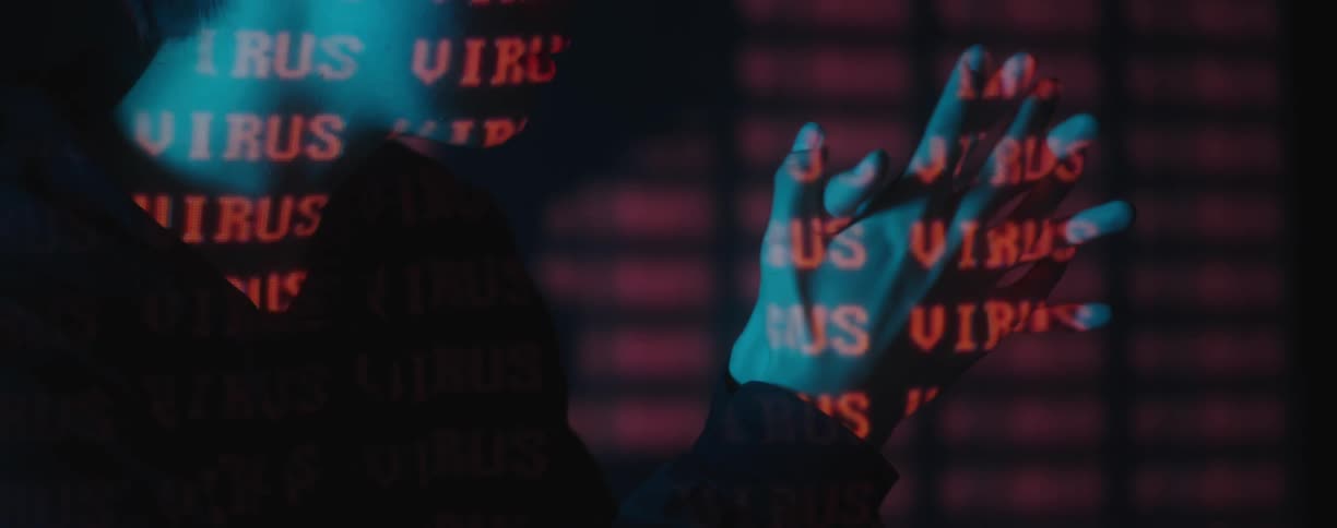 The word virus is displayed on a model posing sideways in front of a digital screen